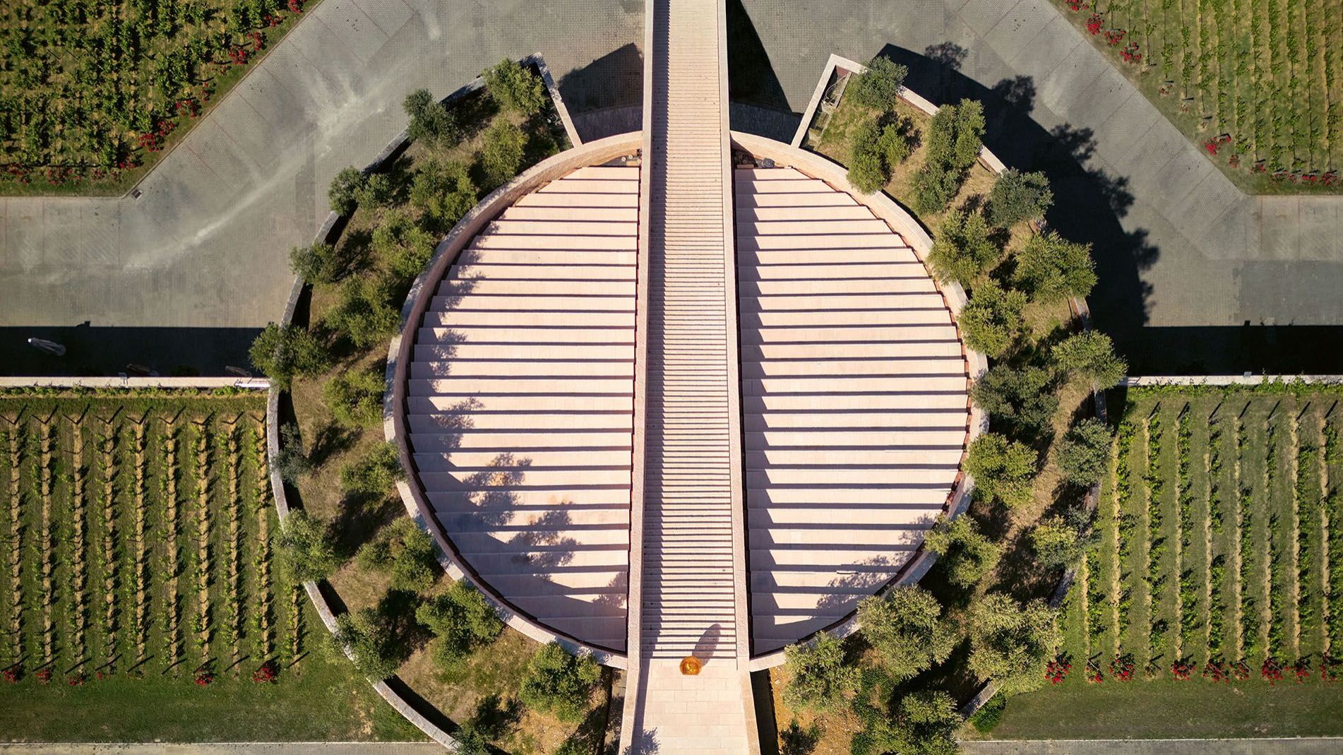  Petra Winery. The sloping roof of the sectioned cylinder is dotted with hanging gardens and a scenic staircase creates a groove down the axis. 